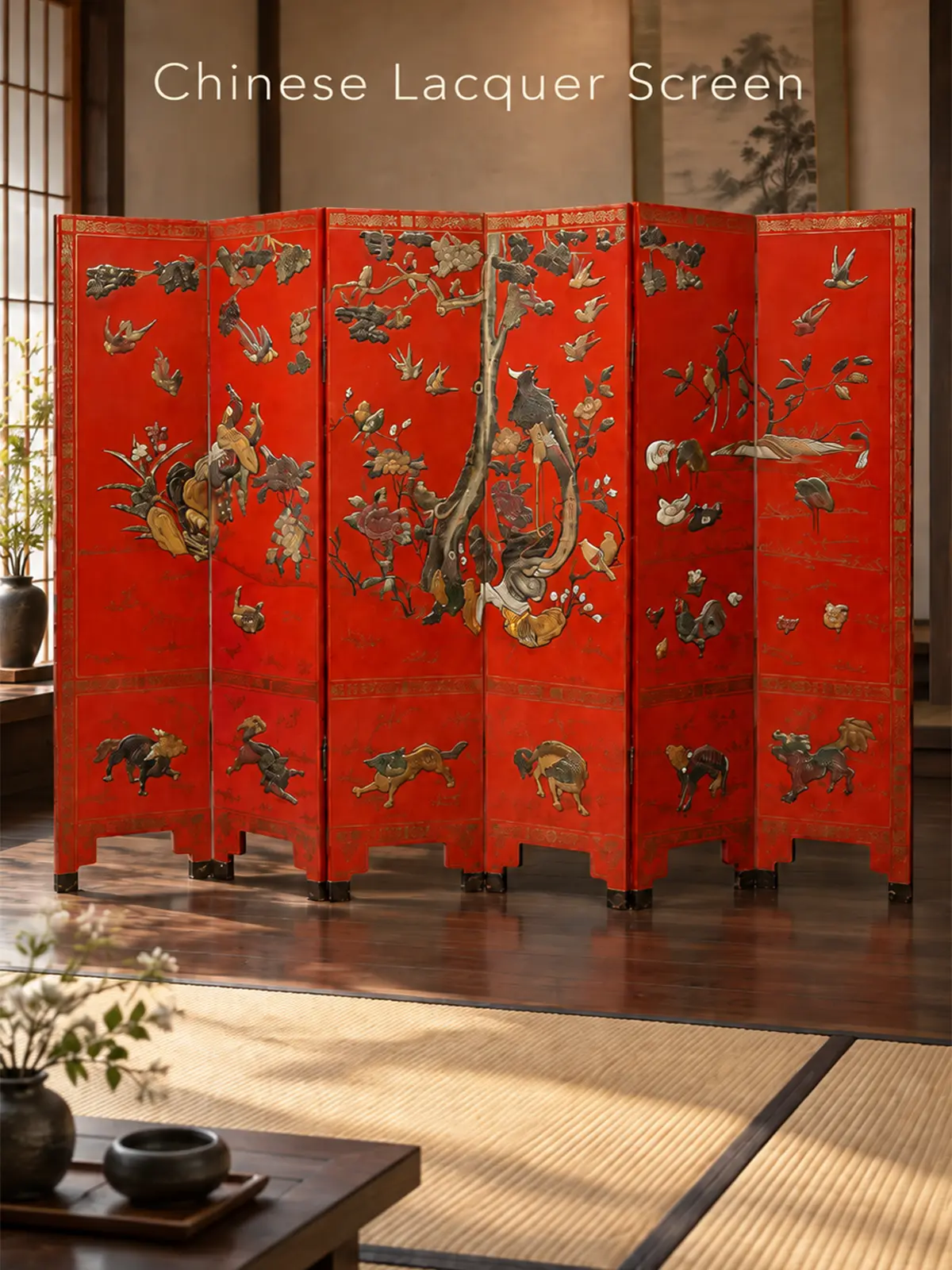 Red Chinese lacquer folding screen with birds, flowering branches, and animal motifs displayed in a Japanese-style interior.