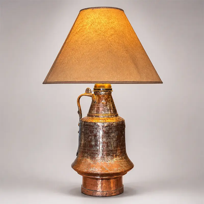 Antique hammered copper vessel table lamp, probably Turkish or Greek, with forged iron handle and warm parchment shade.